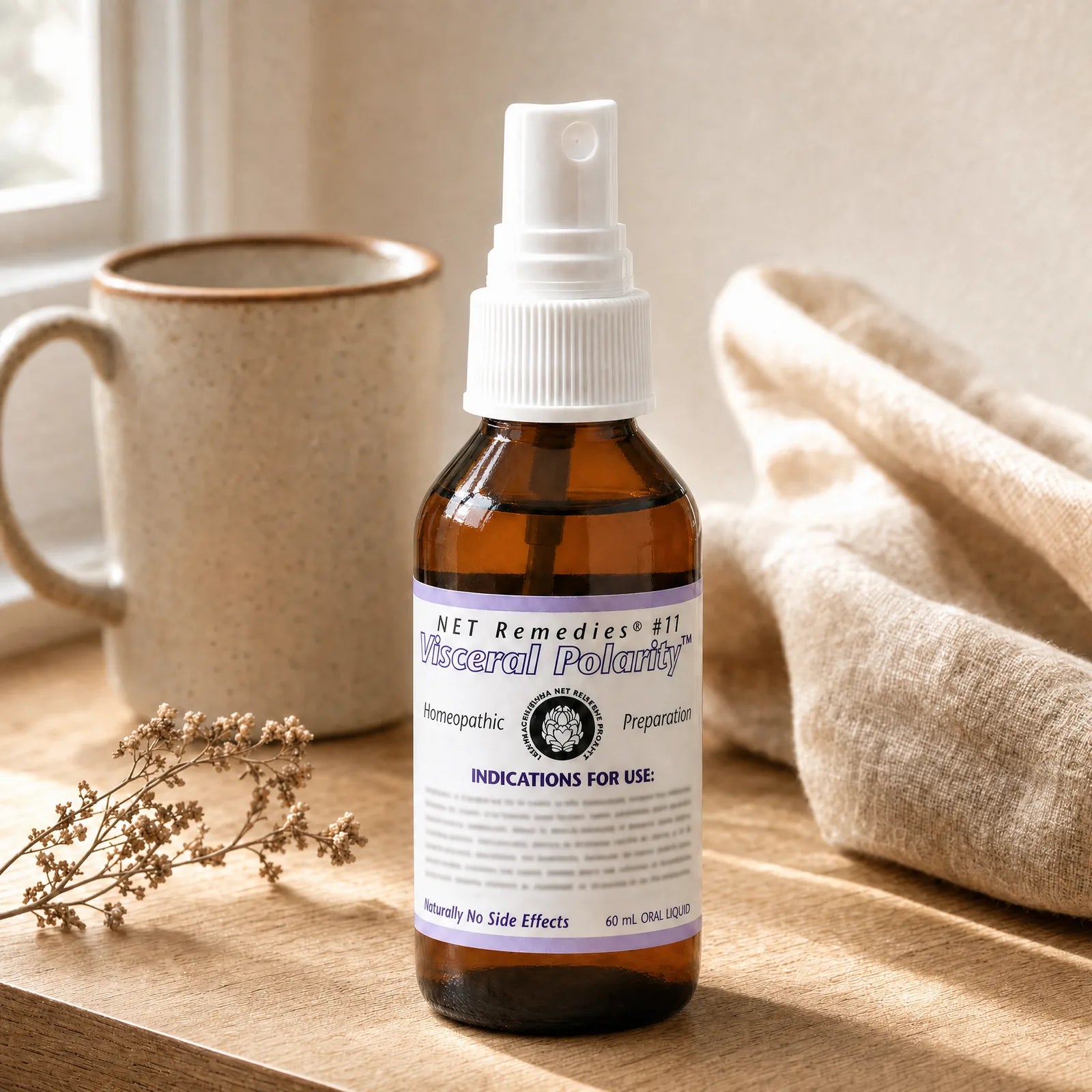 NET Remedies #11 Visceral Polarity homeopathic oral spray on a sunlit windowsill beside a ceramic mug