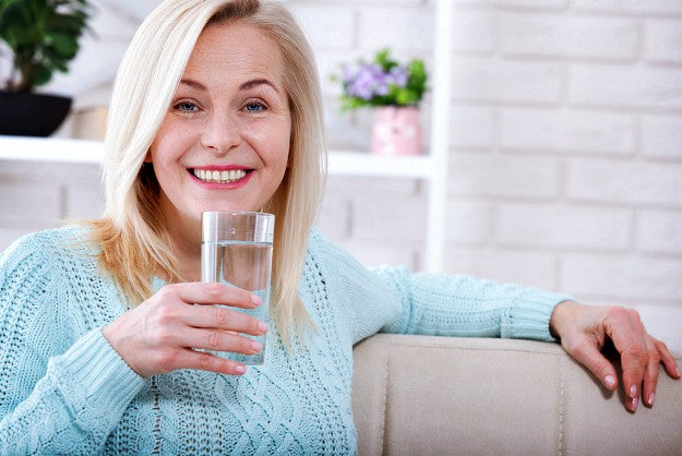 beautiful middle aged woman drinking water