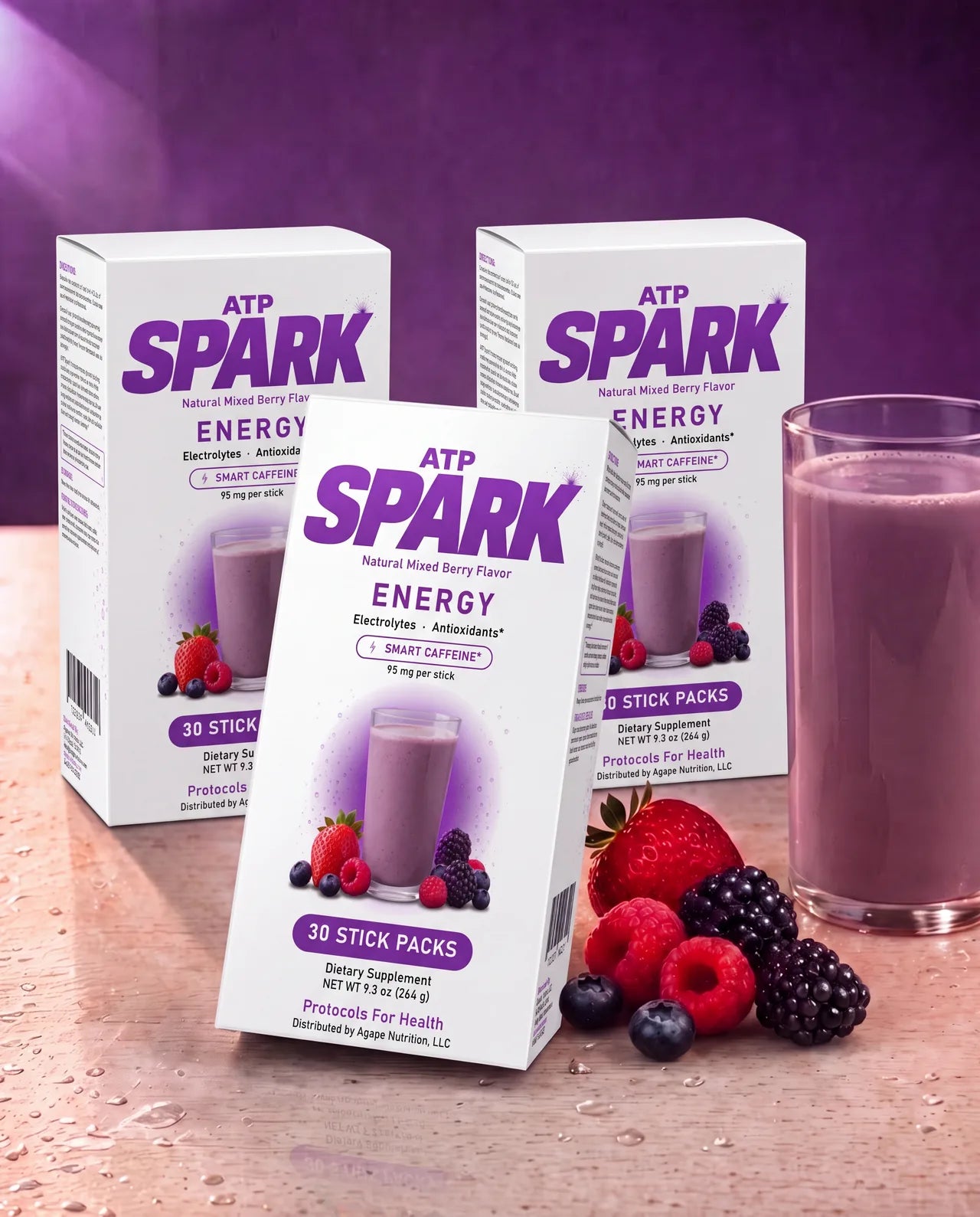 Three ATP SPARK Mixed Berry boxes with a glass of deep-berry fizzing drink and fresh strawberries, raspberries, blueberries and blackberries