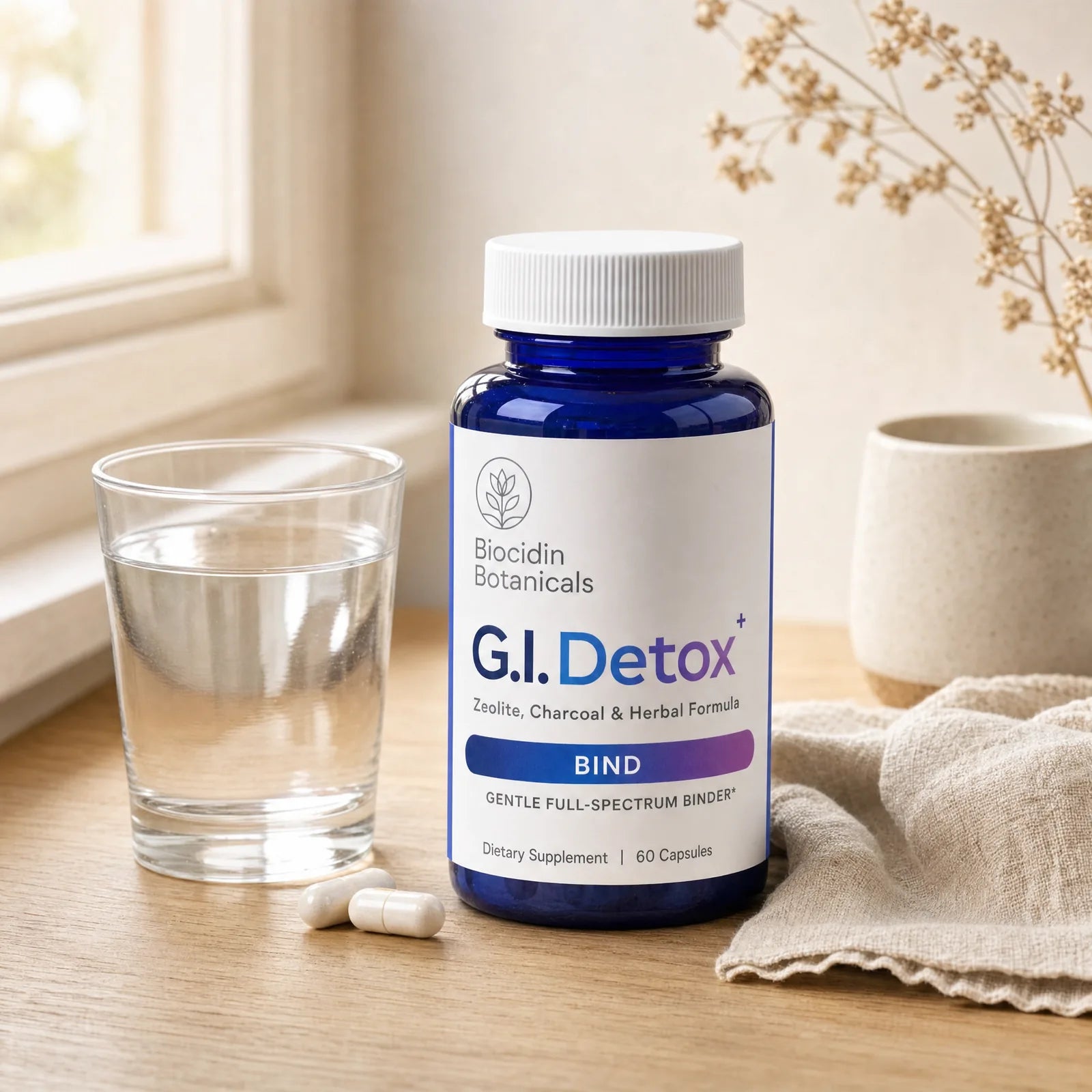 Biocidin Botanicals G.I. Detox+ bottle with a glass of water in a calm morning setting