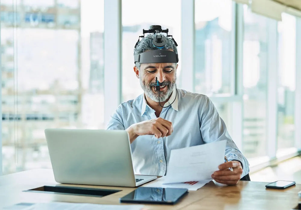 Person working through an afternoon at a desk, the focus context for the Vielight Neuro Duo 4